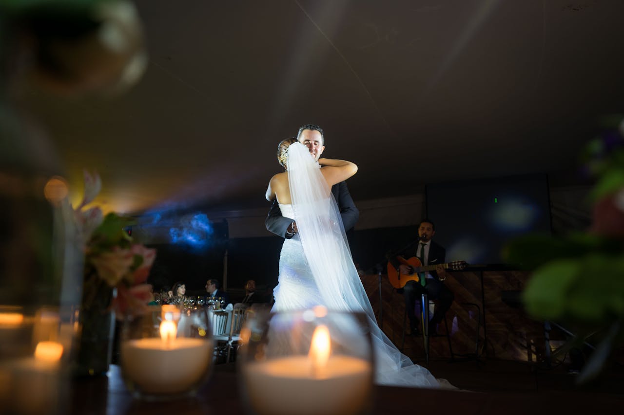 Crafting Captivating Headlines: Your awesome post title goes here Romantic wedding dance scene with bride and groom embraced, surrounded by candles and live music.